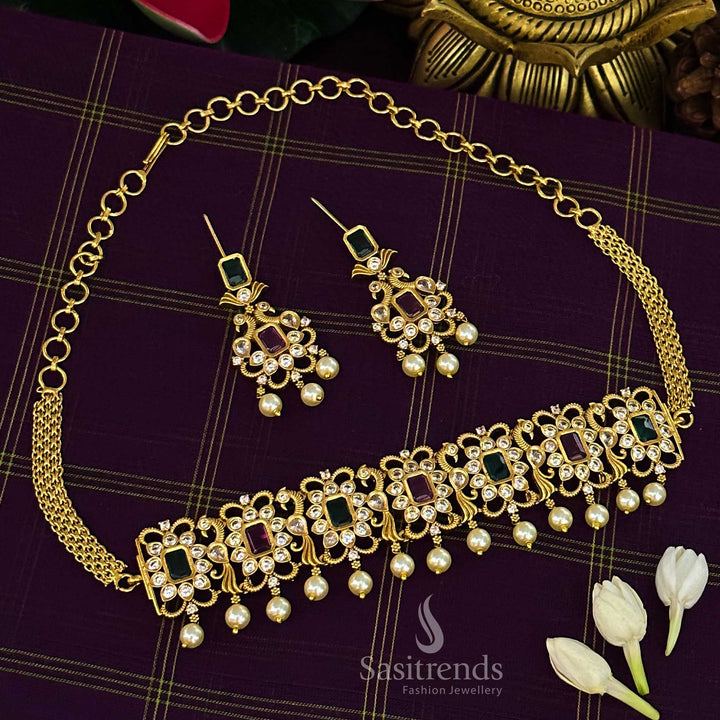 Striking ruby-green combination temple choker jewellery set with iconic peacock centrepiece, matte gold finish and sparkling AD crystal stones for celebration style – Sasitrends