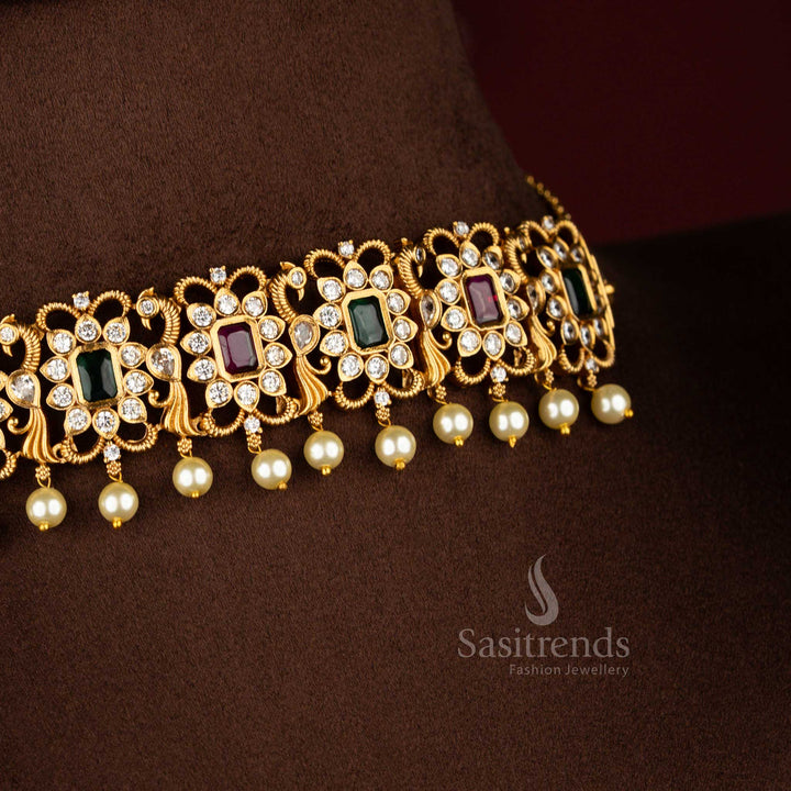 Striking ruby-green combination temple choker jewellery set with iconic peacock centrepiece, matte gold finish and sparkling AD crystal stones for celebration style – Sasitrends
