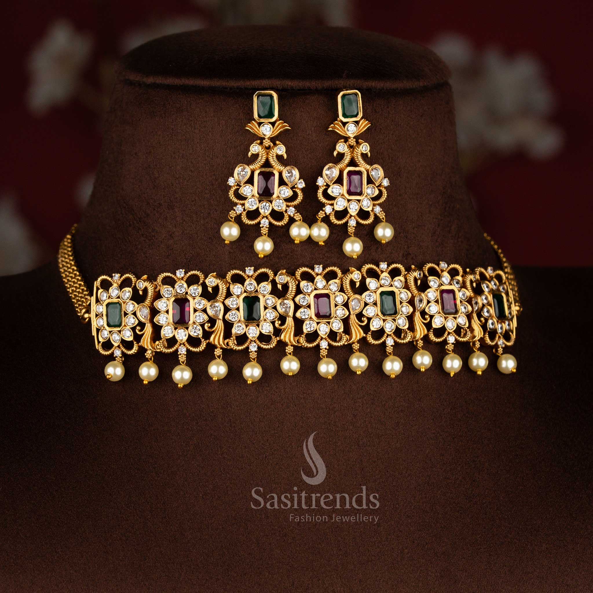 ruby-green combination temple choker jewellery set with iconic peacock centrepiece, matte gold finish and sparkling AD crystal stones for celebration style – Sasitrends