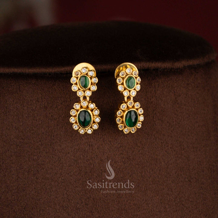 Matte gold plated green-colored oval floral AD earrings for festive ensembles, silk sarees, and ethnic parties – Sasitrends