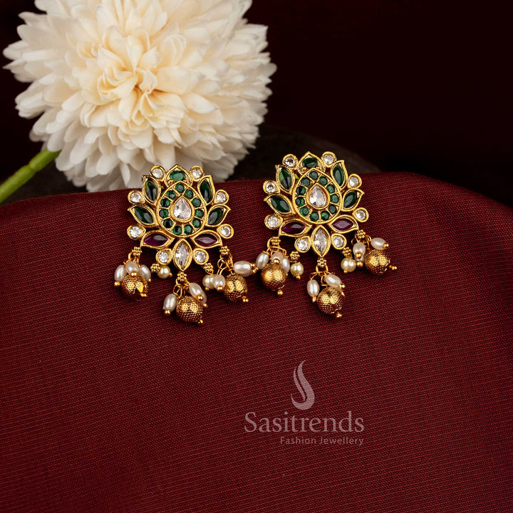 Multi-hue Kemp AD stone lotus earrings with a temple matte gold finish, showcasing ruby and vibrant tones with pearl-bead details for a bold and bright bridal jewellery statement – sasitrends