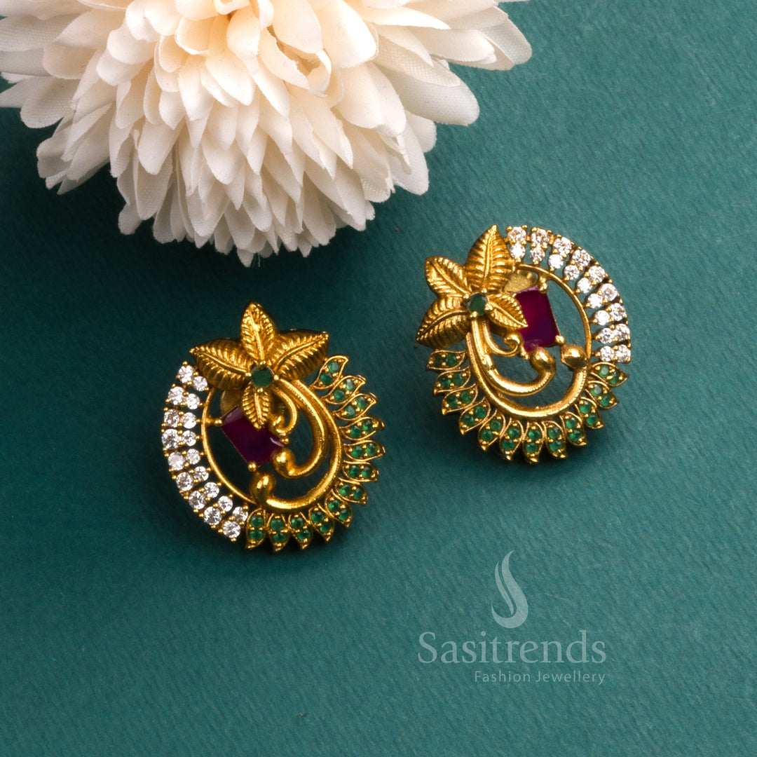 Trendy temple matte gold tone floral earrings adorned with sparkling AD stones and rich ruby tone accents, exuding traditional jewellery elegance for festive occasions - Sasitrends
