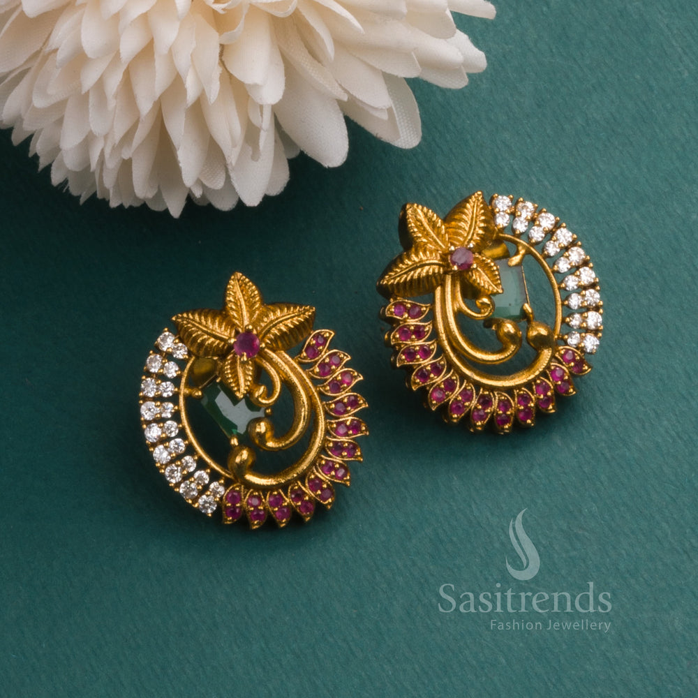 Classic matte gold tone temple earrings featuring a floral motif and vibrant green AD stones, offering a refined festive jewellery look for women - Sasitrends