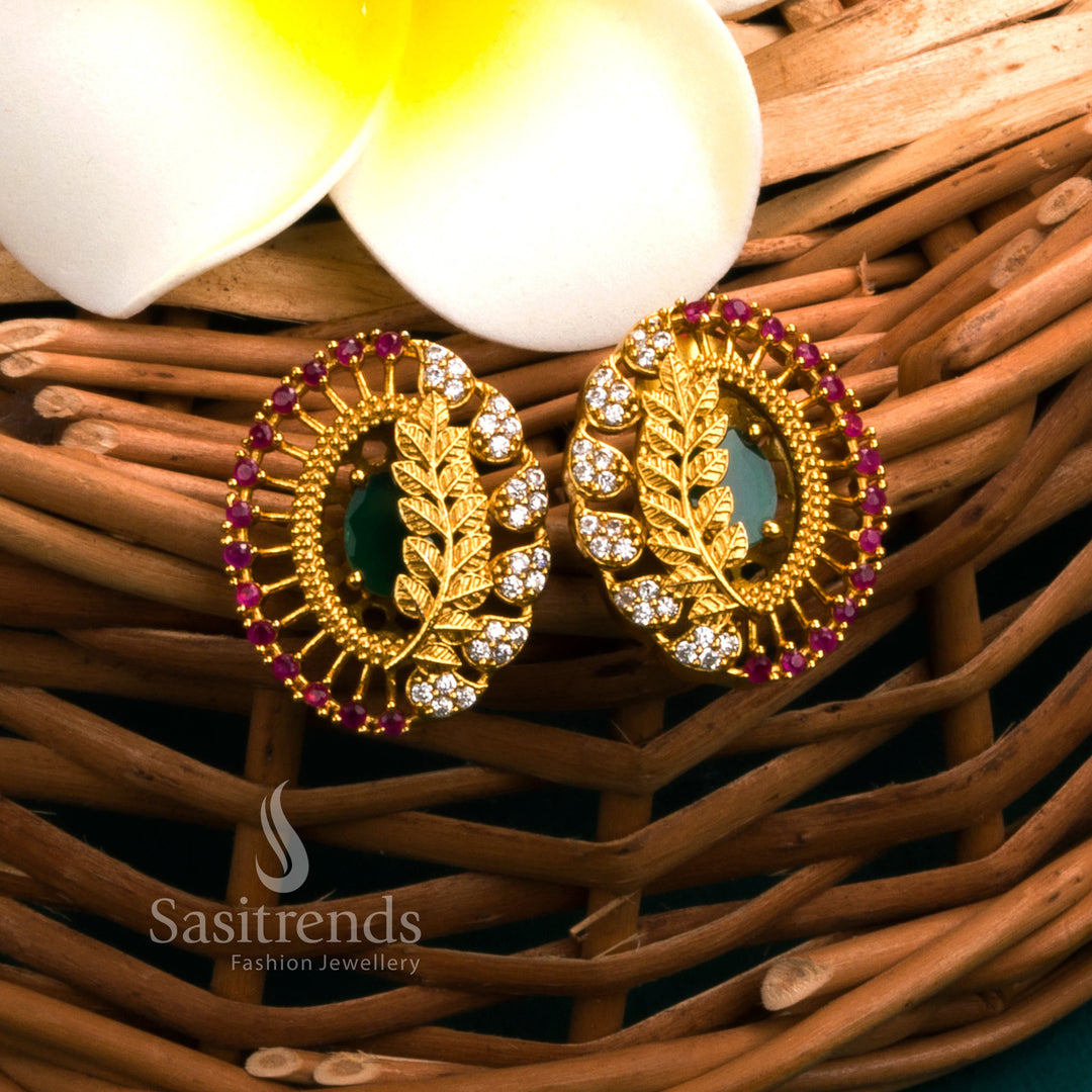 Traditional temple matte gold earrings with leaf design and luminous green AD stones, offering cultural jewellery flair perfect for festive outfits - Sasitrends