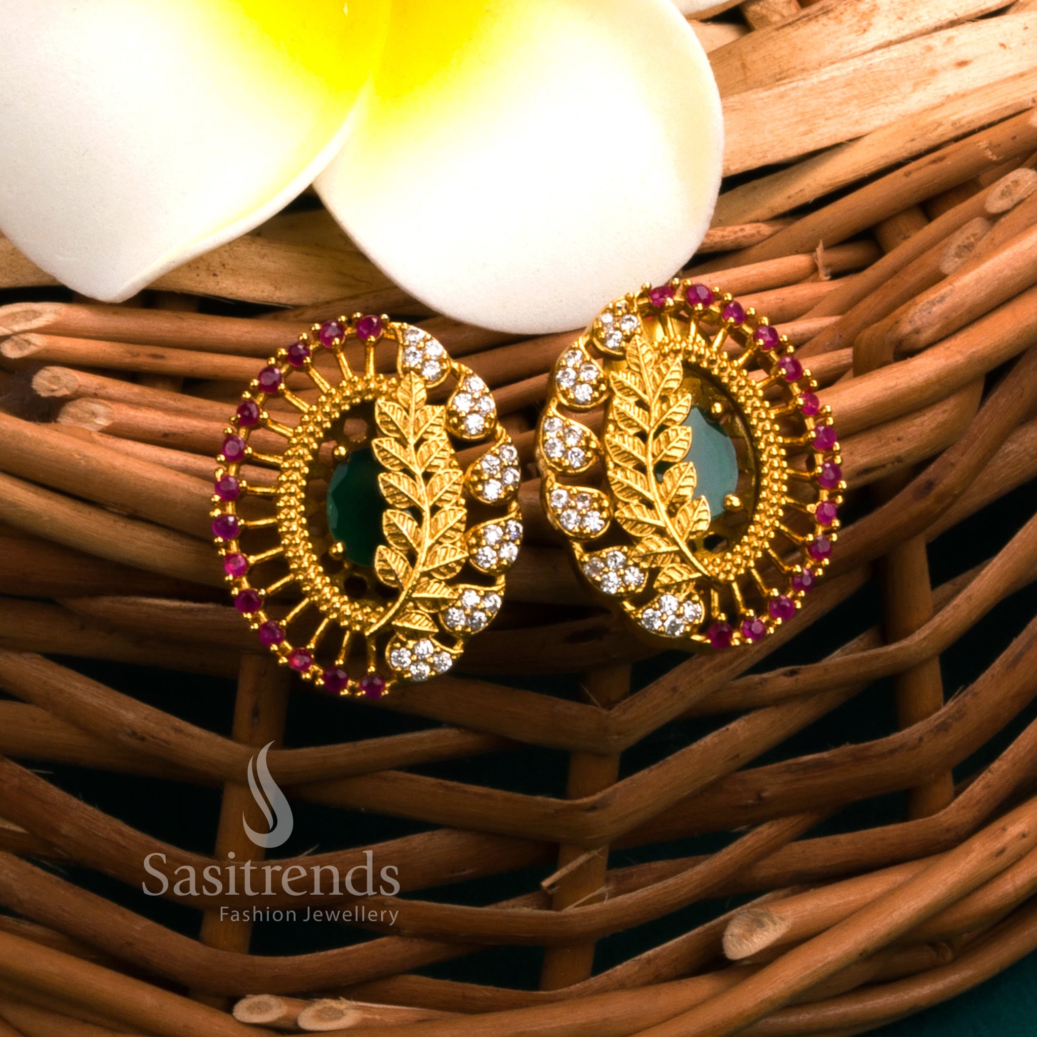 Traditional temple matte gold earrings with leaf design and luminous green AD stones, offering cultural jewellery flair perfect for festive outfits - Sasitrends