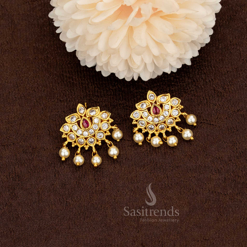 Elegant matte gold lotus motif earrings featuring white and ruby American diamonds accented with radiant pearl drops – Sasitrends