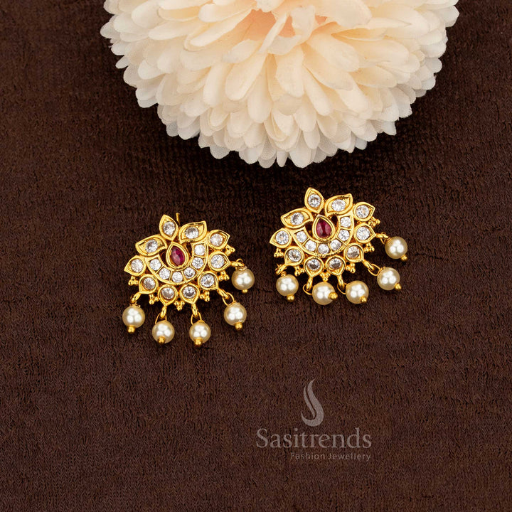 Elegant matte gold lotus motif earrings featuring white and ruby American diamonds accented with radiant pearl drops – Sasitrends