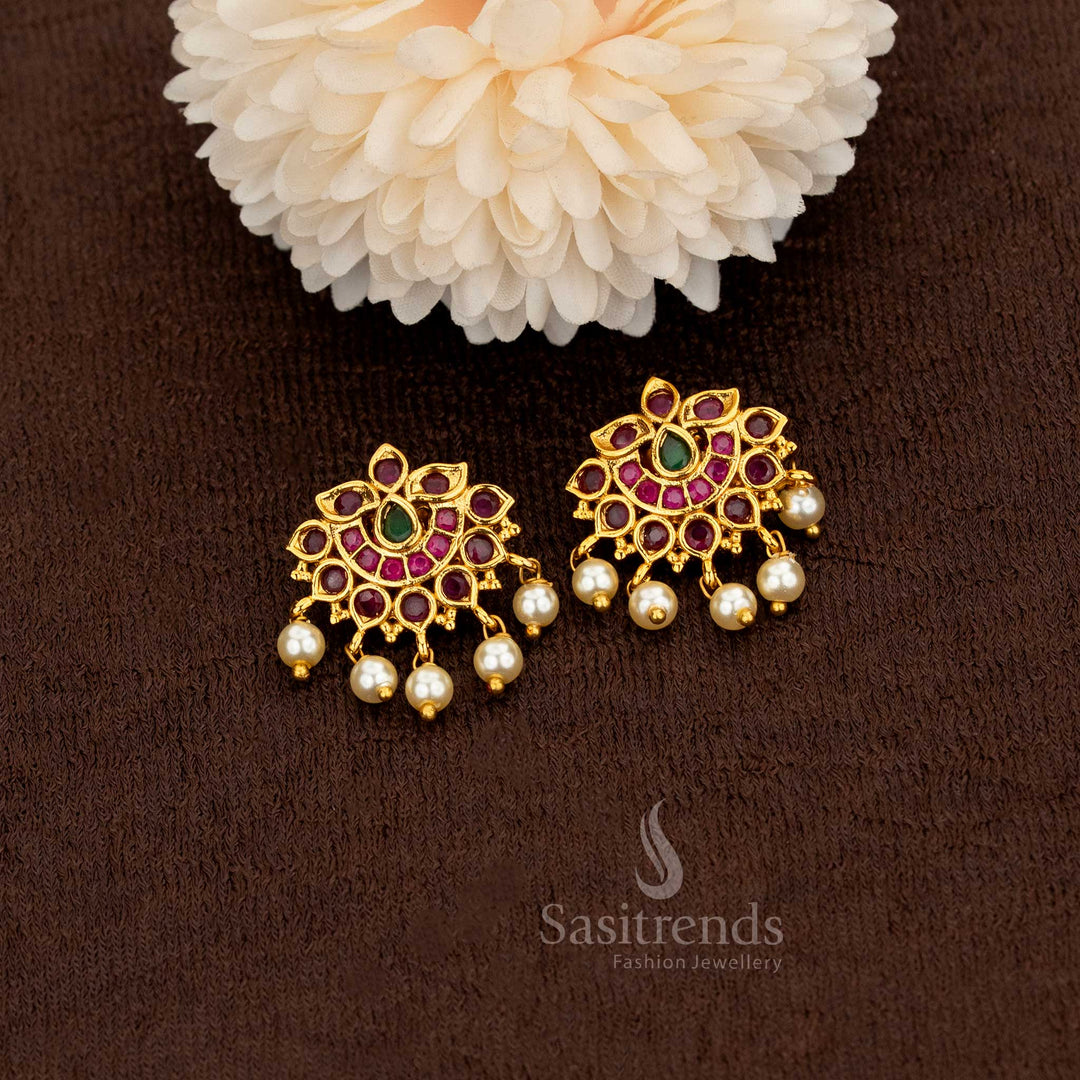 Artfully designed matte gold lotus motif earrings with ruby and green American diamonds completed with lustrous pearl drops – Sasitrends