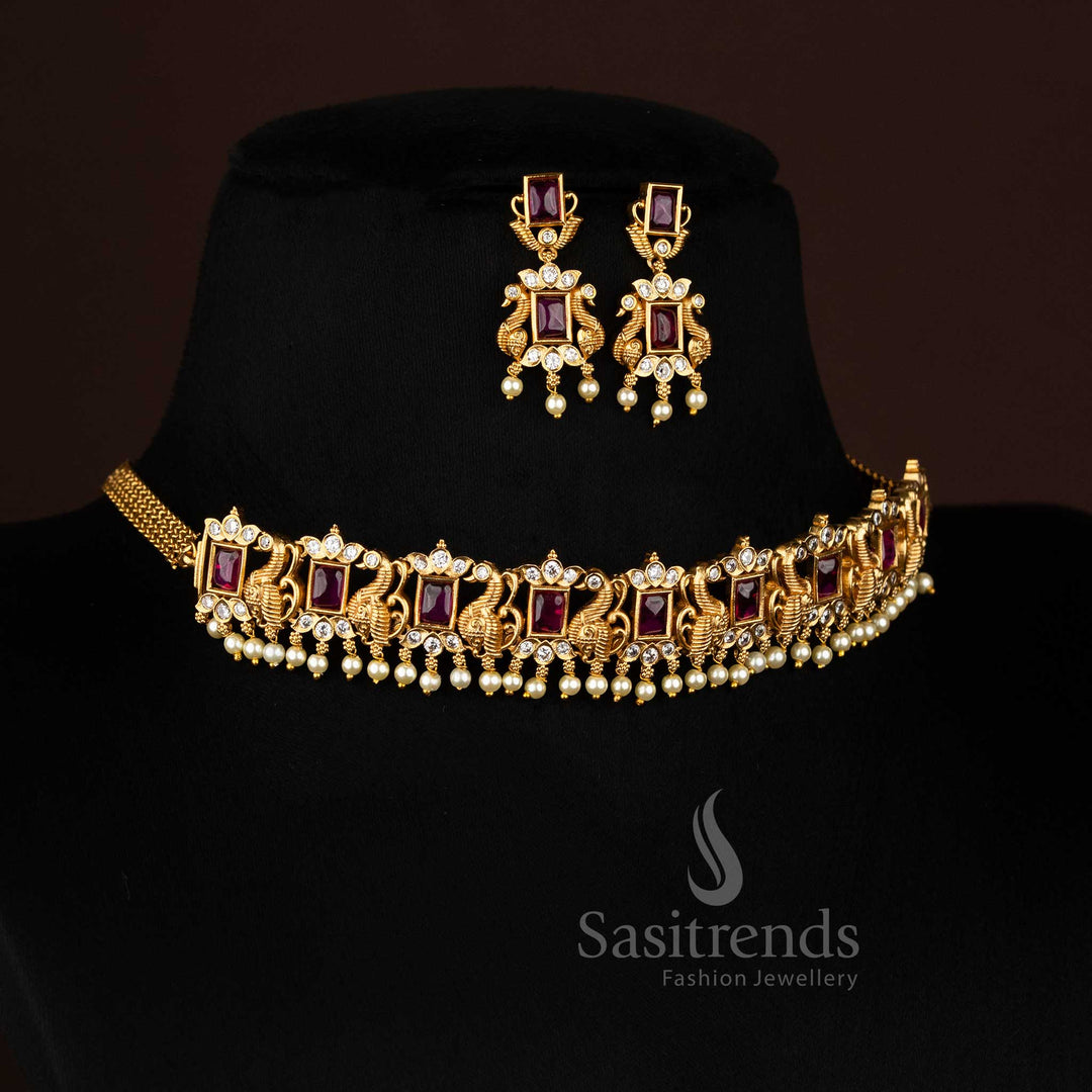 Ornate traditional matte gold plated peacock choker necklace, showcasing an elegant combination of deep ruby and brilliant emerald green stones with AD accents and dangling pearls, ideal for festive occasions from Sasitrends