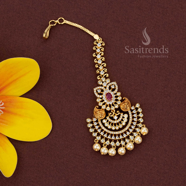 Radiant Micro Gold Plated AD Stone Crescent Maang Tikka with Floral Paisley Motifs and Pearl Drops for Cultural Gatherings
