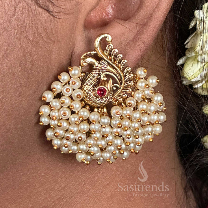 Breathtaking temple-style matte gold plated peacock bunch earrings with intricate feather carvings, radiating royal ethnic jewellery glamour and traditional finesse for festive occasions – sasitrends

