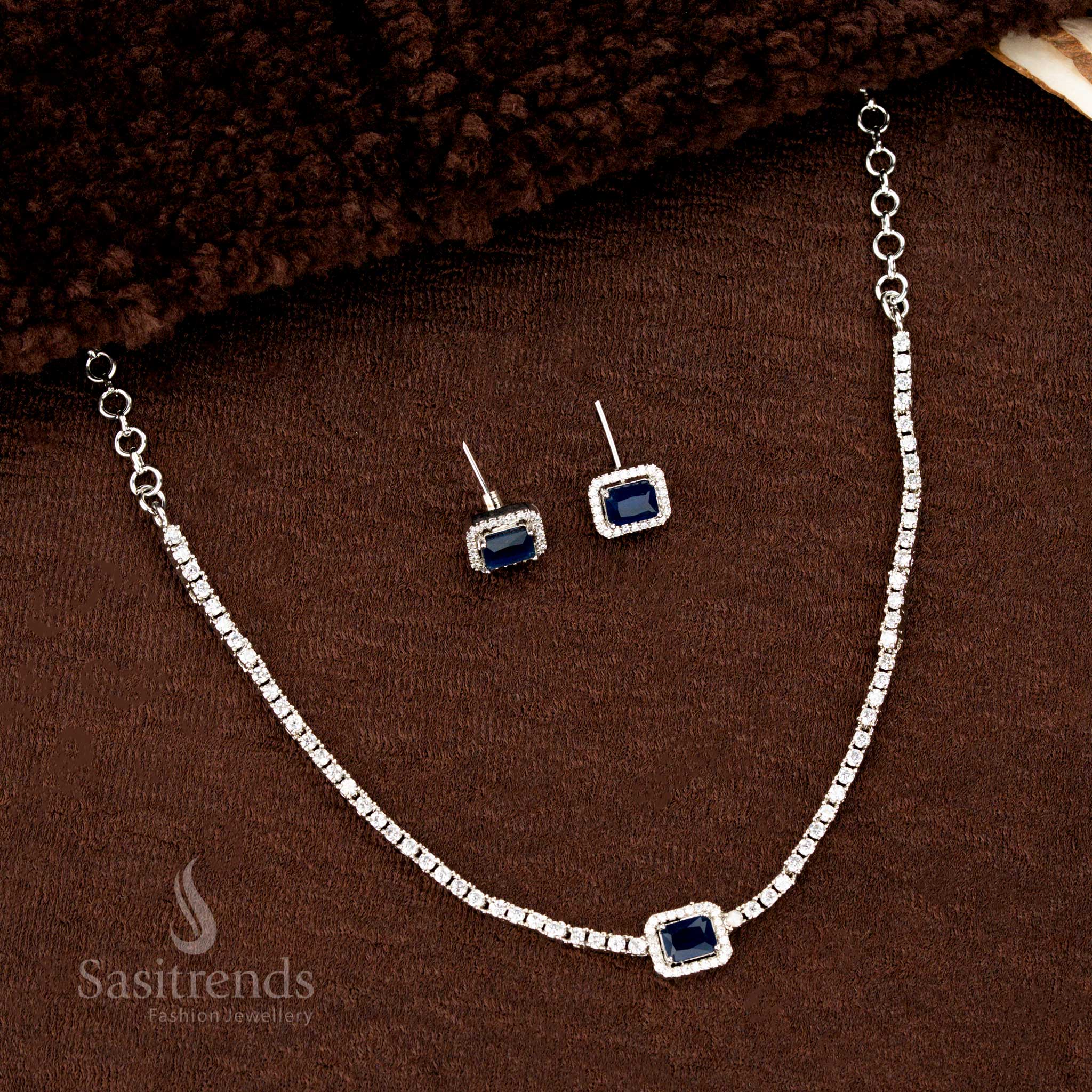 Deep blue American diamond rectangle necklace set with rhodium silver layer and glittering earrings – a luxurious and rich-toned jewellery design for evening wear by Sasitrends