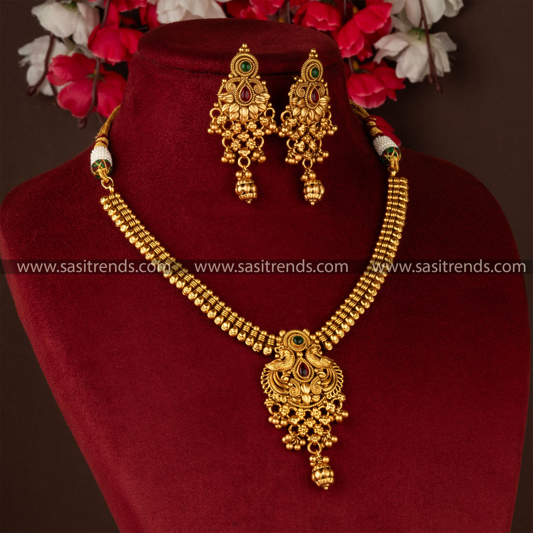 Antique gold-plated peacock and floral brass jewellery set with earrings, perfect for traditional events