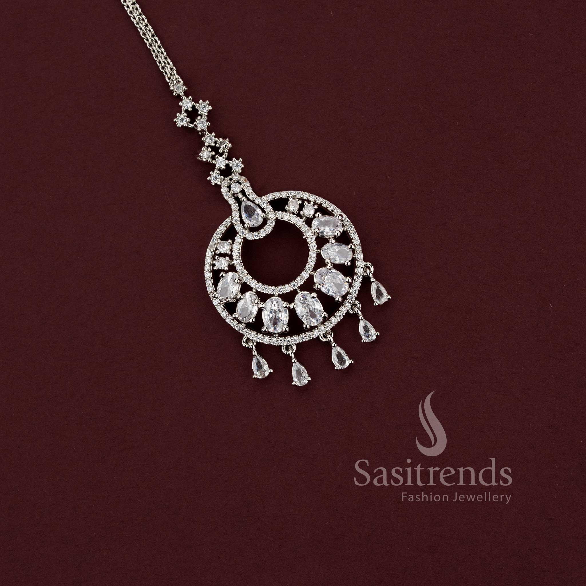 Sophisticated silver AD stone maang tikka for bridal or engagement looks, ideal for pairing with a lehenga, featuring dangling pear drops, style - Sasitrends