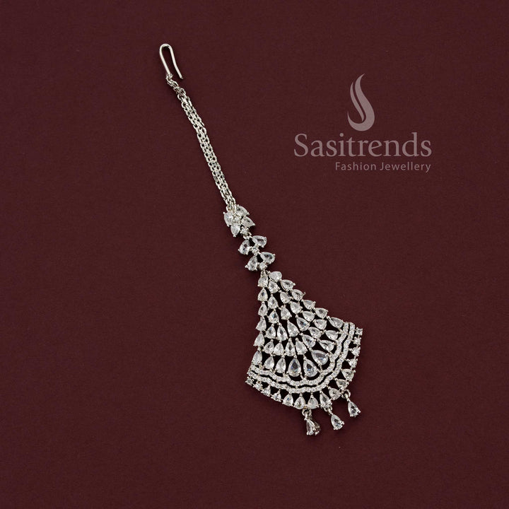 Heavy bridal rhodium silver maang tikka featuring a grand shield-shaped fan design with rows of pear American Diamonds, perfect for wedding lehengas and grand events - Sasitrends