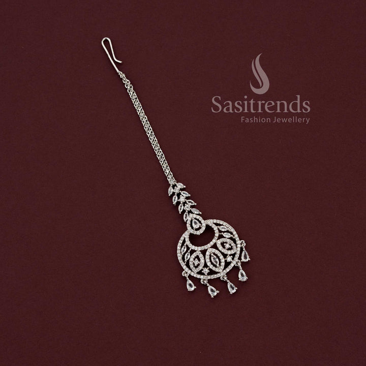 Heavy bridal rhodium silver maang tikka 2129E featuring an intricate American Diamond filigree crescent pendant with a decorative lattice design, perfect for engagement and wedding lehengas