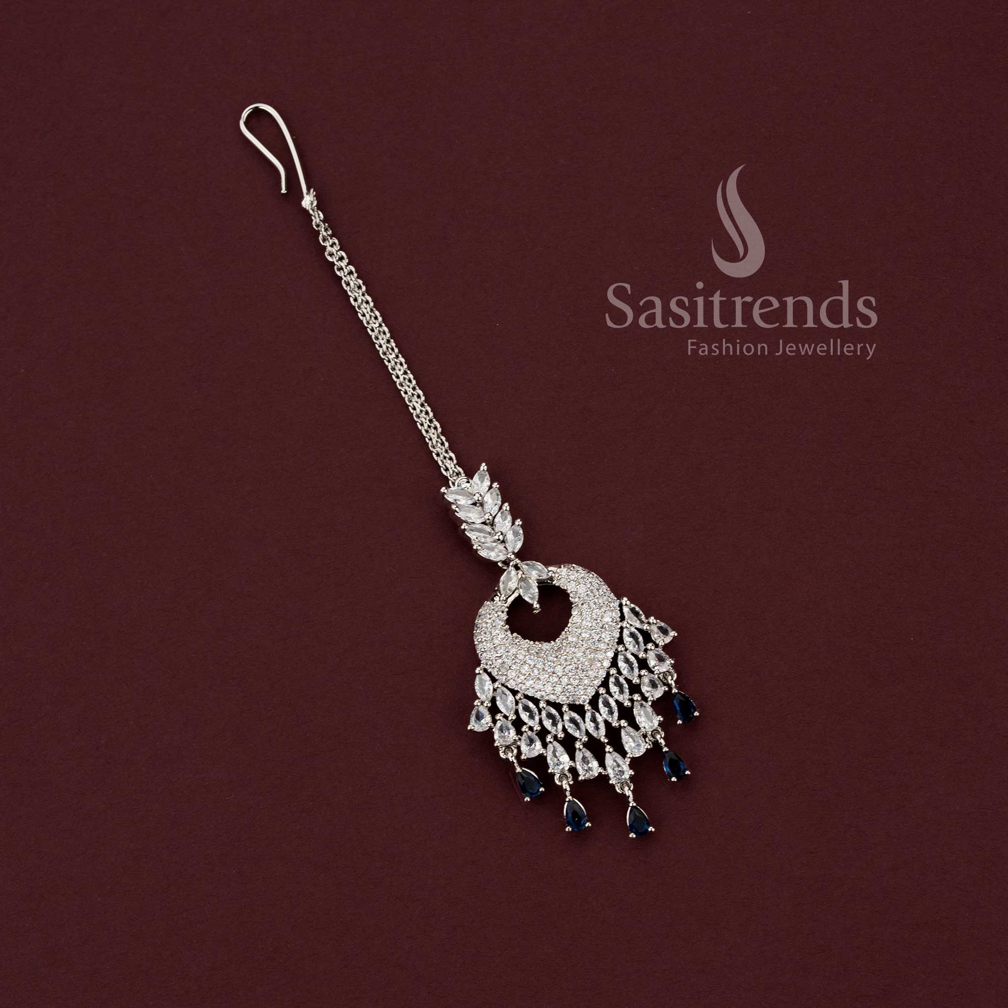 Timeless bridal rhodium silver maang tikka 2129F featuring a heart-shaped American Diamond pavé pendant with clear white stone drops, perfect for engagement lehengas and wedding jewelry sets