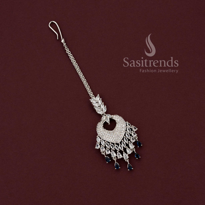Timeless bridal rhodium silver maang tikka 2129F featuring a heart-shaped American Diamond pavé pendant with clear white stone drops, perfect for engagement lehengas and wedding jewelry sets