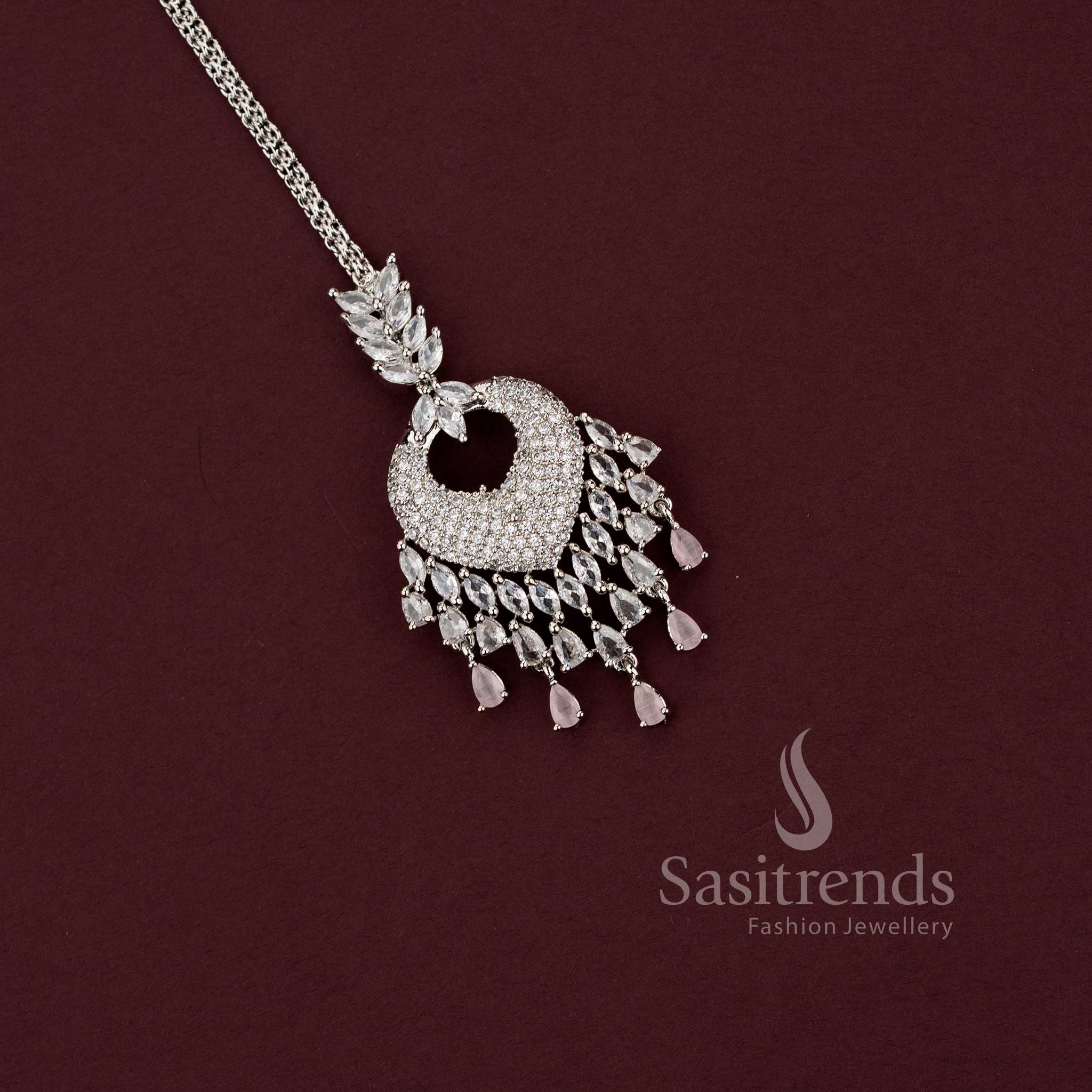 Elegant party wear silver AD stone maang tikka 2129F with a spade-style motif and a wide chandelier fringe of pink pear drops, a stunning accessory for silk sarees and festive celebrations