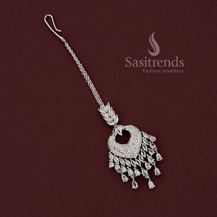 Timeless bridal rhodium silver maang tikka 2129F featuring a heart-shaped American Diamond pavé pendant with clear white stone drops, perfect for engagement lehengas and wedding jewelry sets