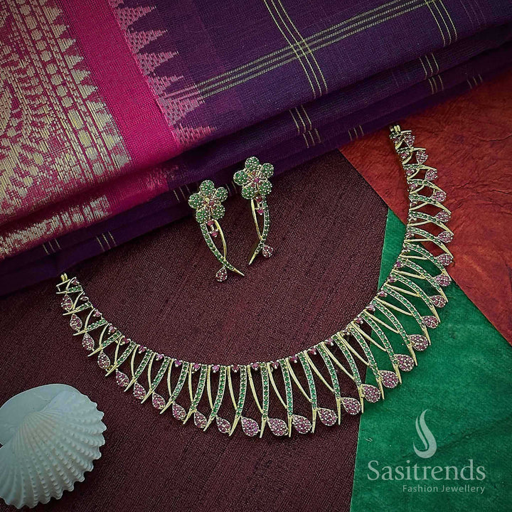 Ruby and green floral temple choker jewellery set with dual-tone kemp stones in matte gold finish – ideal for traditional style and festive charm – Sasitrends
