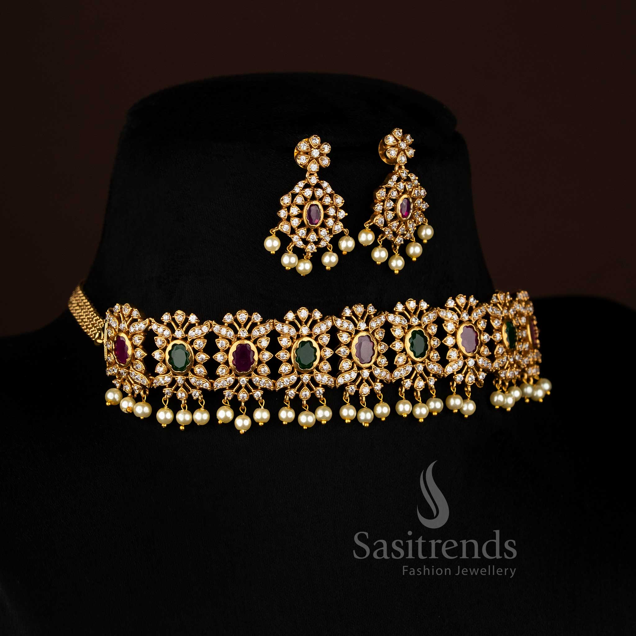 Vibrant ruby Green stone floral choker jewellery set with temple matte gold plating, pearl-laced contours, and artistic AD sparkle, perfect for celebratory occasions – Sasitrends
