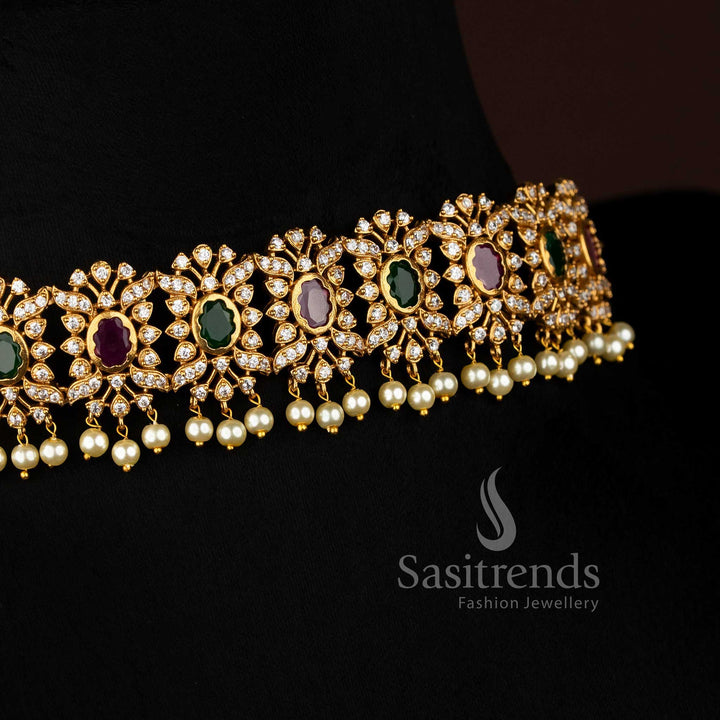 Vibrant ruby Green stone floral choker jewellery set with temple matte gold plating, pearl-laced contours, and artistic AD sparkle, perfect for celebratory occasions – Sasitrends