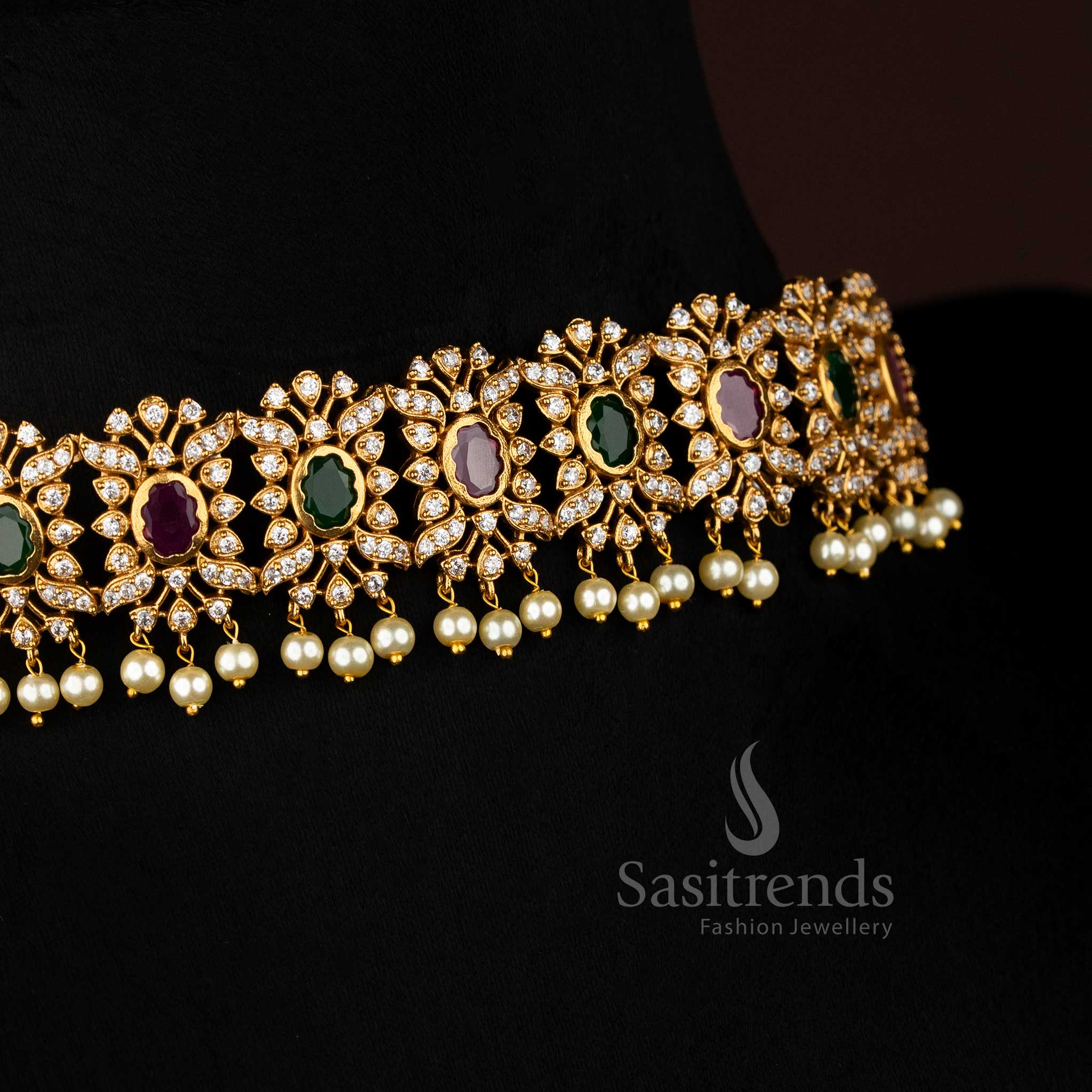 Vibrant ruby Green stone floral choker jewellery set with temple matte gold plating, pearl-laced contours, and artistic AD sparkle, perfect for celebratory occasions – Sasitrends