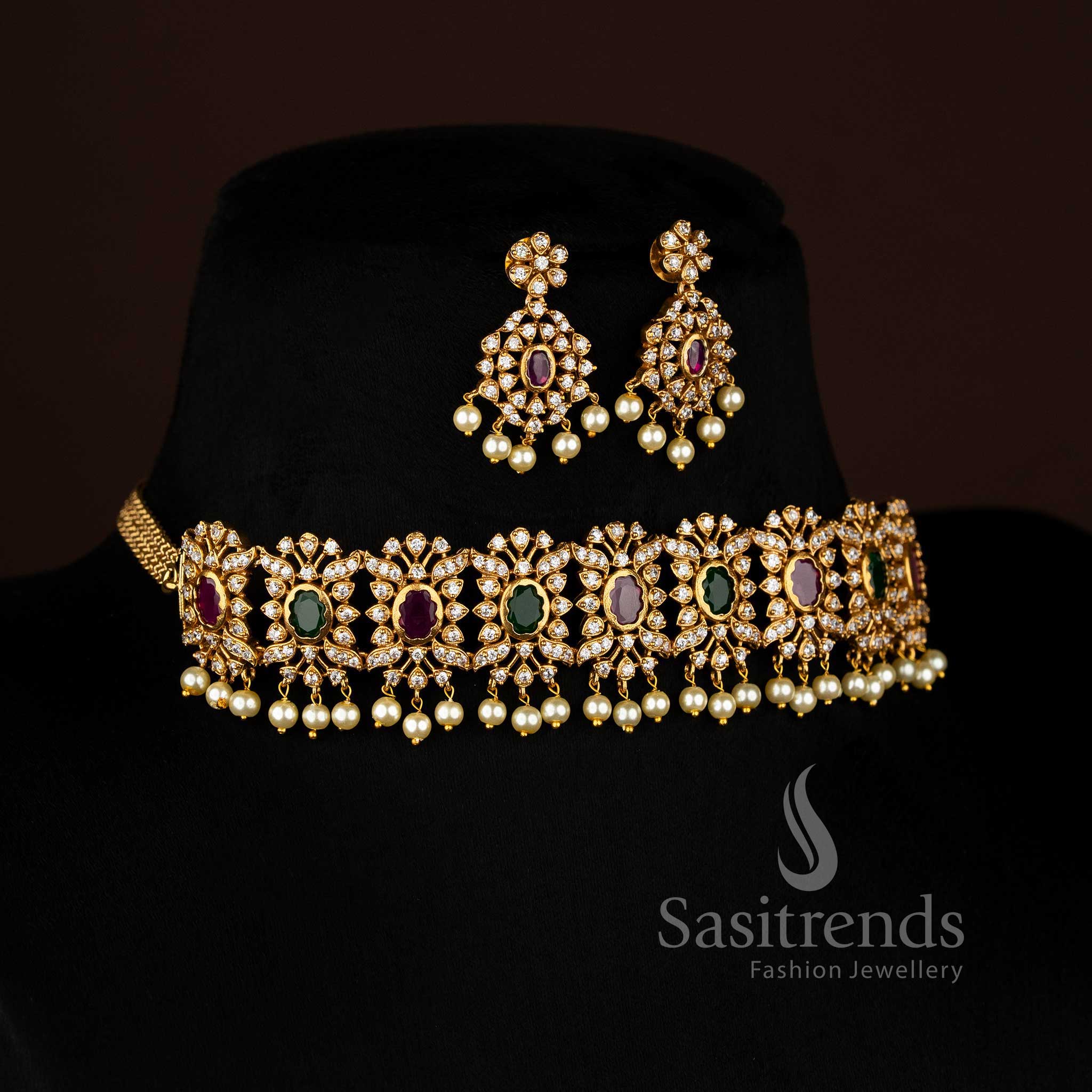 Vibrant ruby Green stone floral choker jewellery set with temple matte gold plating, pearl-laced contours, and artistic AD sparkle, perfect for celebratory occasions – Sasitrends