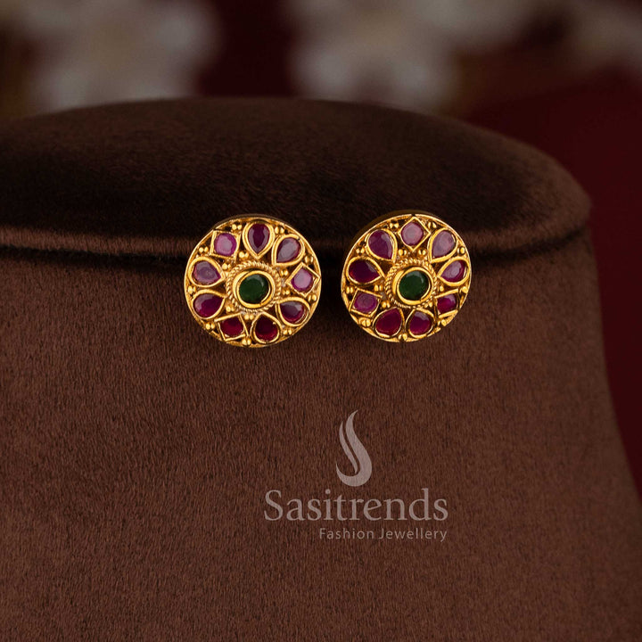 Elegant temple matte gold peacock choker set with ruby and green stones and matching jhumkas.