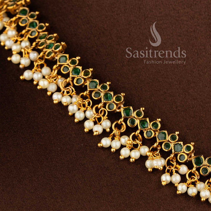 Gorgeous floral pendant temple matte gold plated choker necklace set with AD stones and pearl drops in green by Sasitrends.