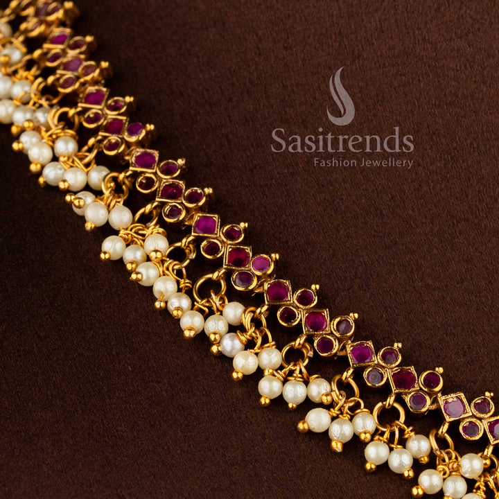 Gorgeous floral pendant temple matte gold plated choker necklace set with AD stones and pearl drops in ruby by Sasitrends.