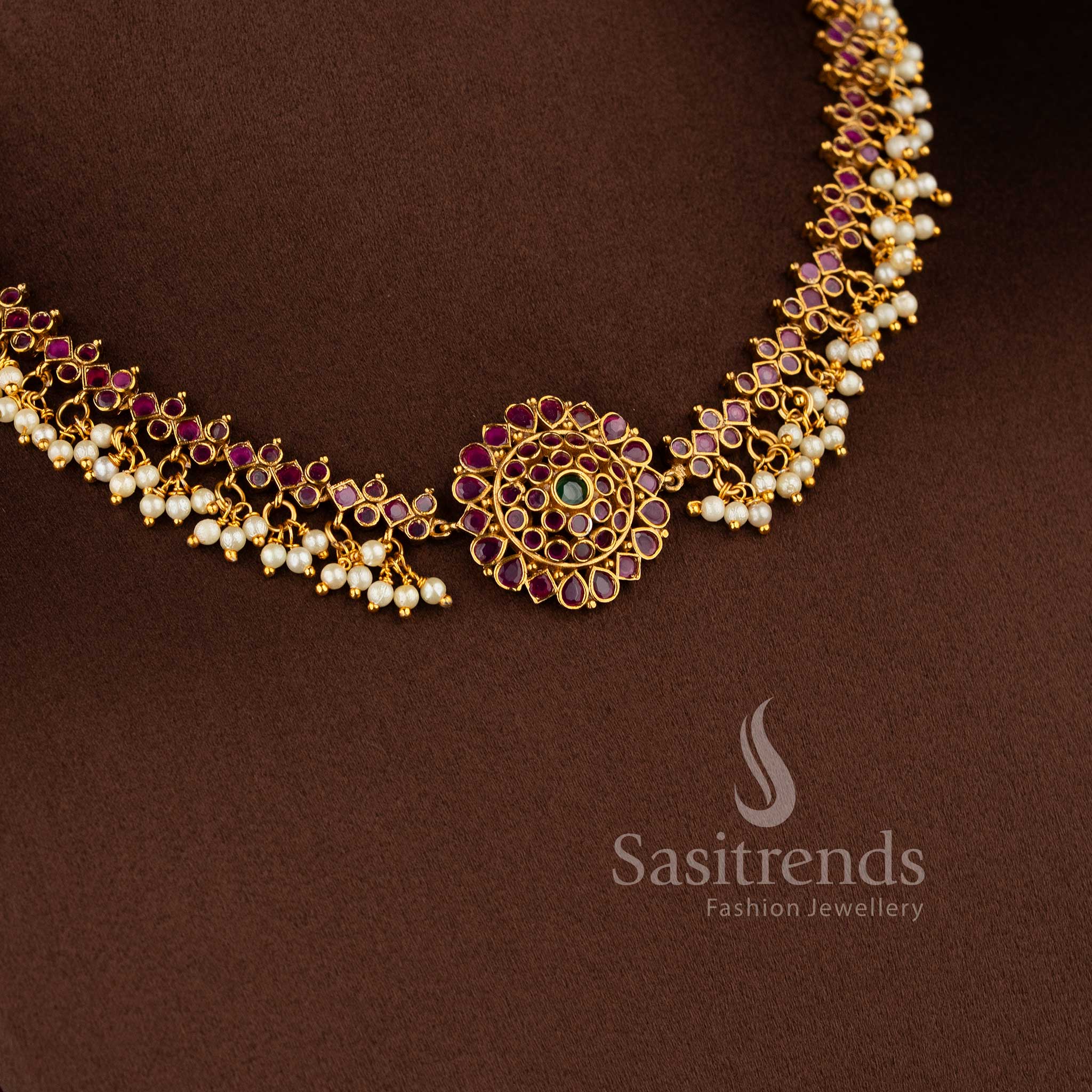 Gorgeous floral pendant temple matte gold plated choker necklace set with AD stones and pearl drops in ruby green by Sasitrends.