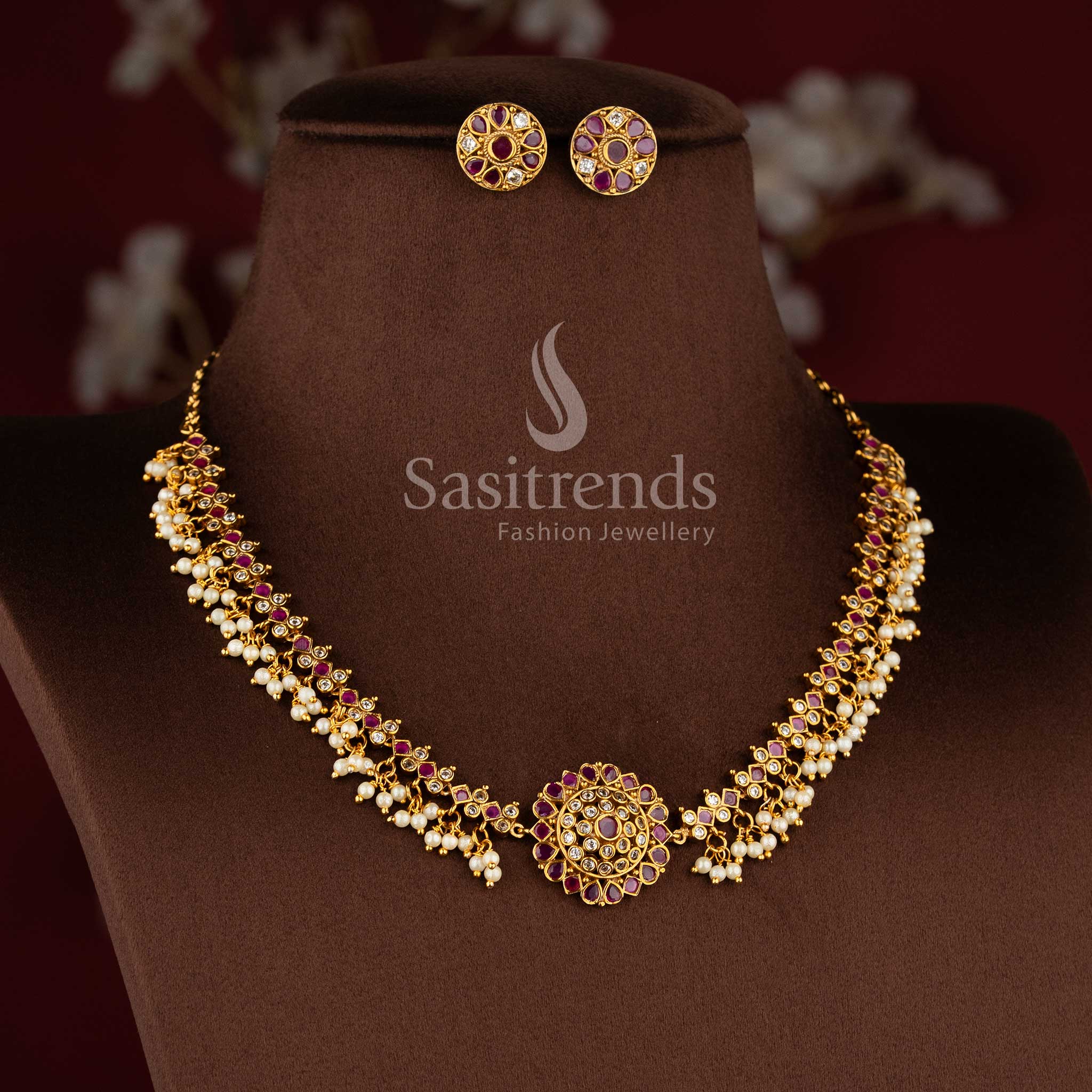Elegant matte gold floral necklace set with ruby stone and pearl detailing for women.