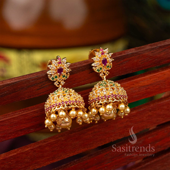 Radiant traditional micro gold finished AD pearl jhumka earrings featuring intricate carvings and ethereal pearl hangings – timeless festive wear – Sasitrends