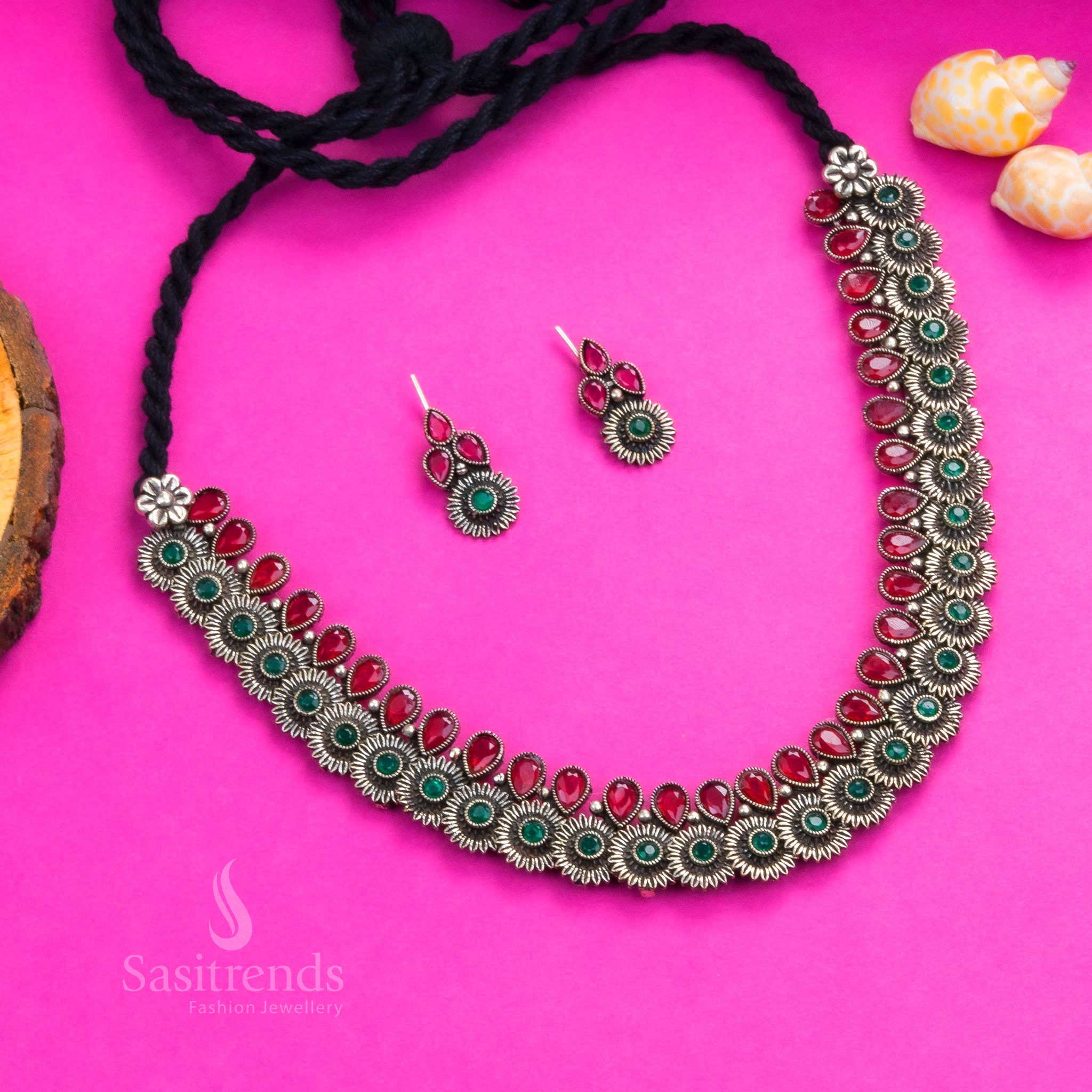 Heritage-inspired oxidised floral necklace set featuring ruby-green tear drop stones, floral motifs, and detailed earrings - Sasitrends