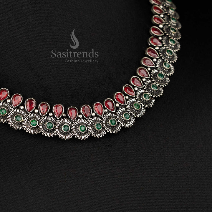 Heritage-inspired oxidised floral necklace set featuring ruby-green tear drop stones, floral motifs, and detailed earrings - Sasitrends