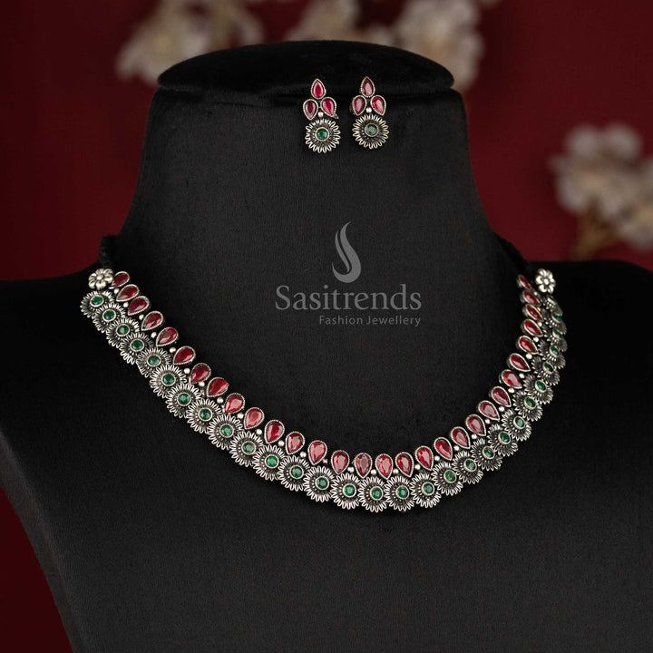 Heritage-inspired oxidised floral necklace set featuring ruby-green tear drop stones, floral motifs, and detailed earrings - Sasitrends