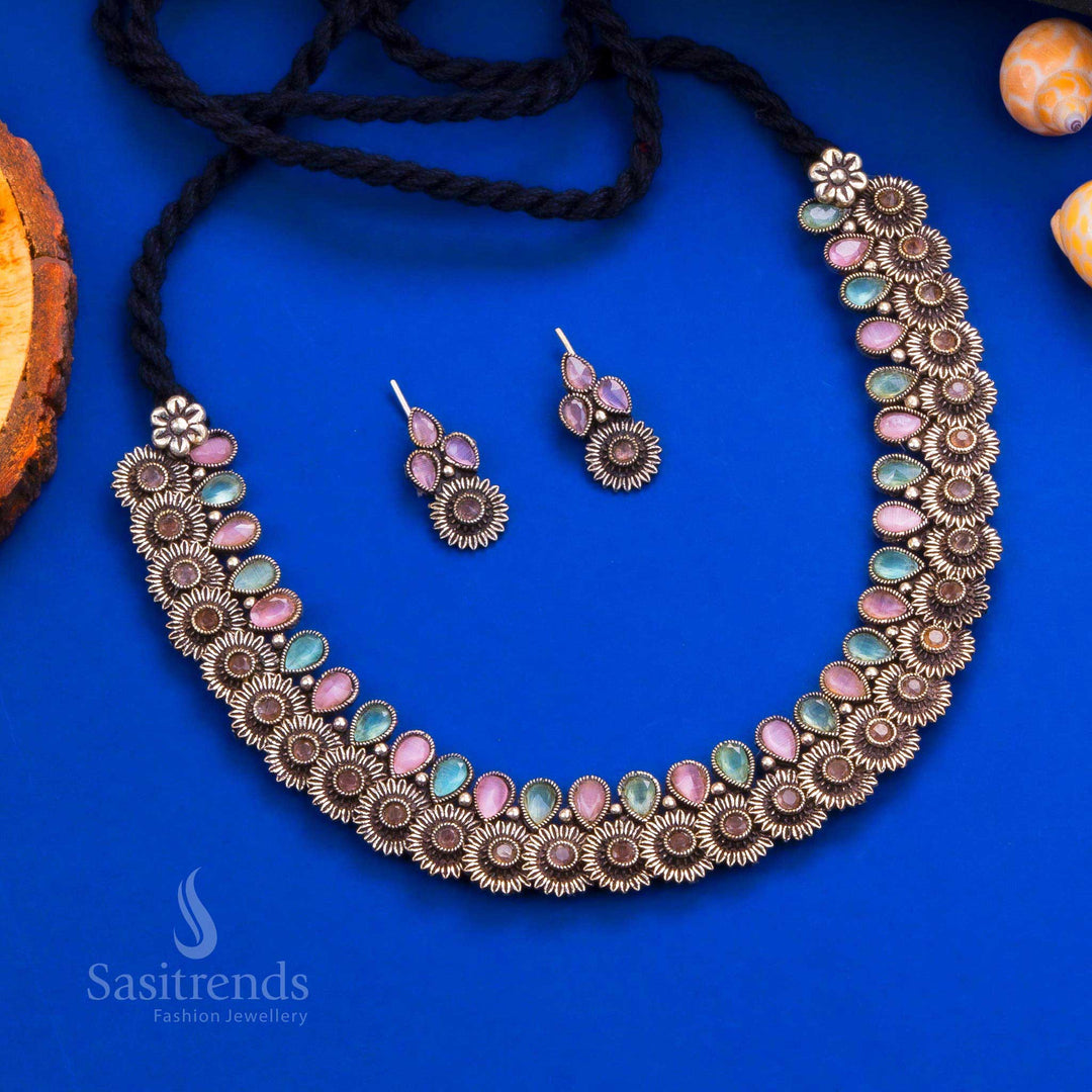 Royal peacock Kushi necklace set in oxidised silver, adorned with mint-pink tear drop stones and matching earrings - Sasitrends