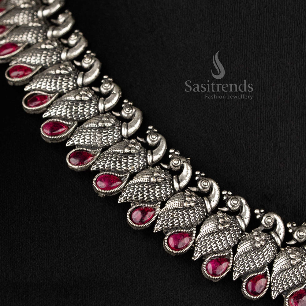 Royal handcrafted oxidised Kushi necklace set in silver, featuring contrasting Ruby -tear drop stones and peacock-shaped earrings - Sasitrends  