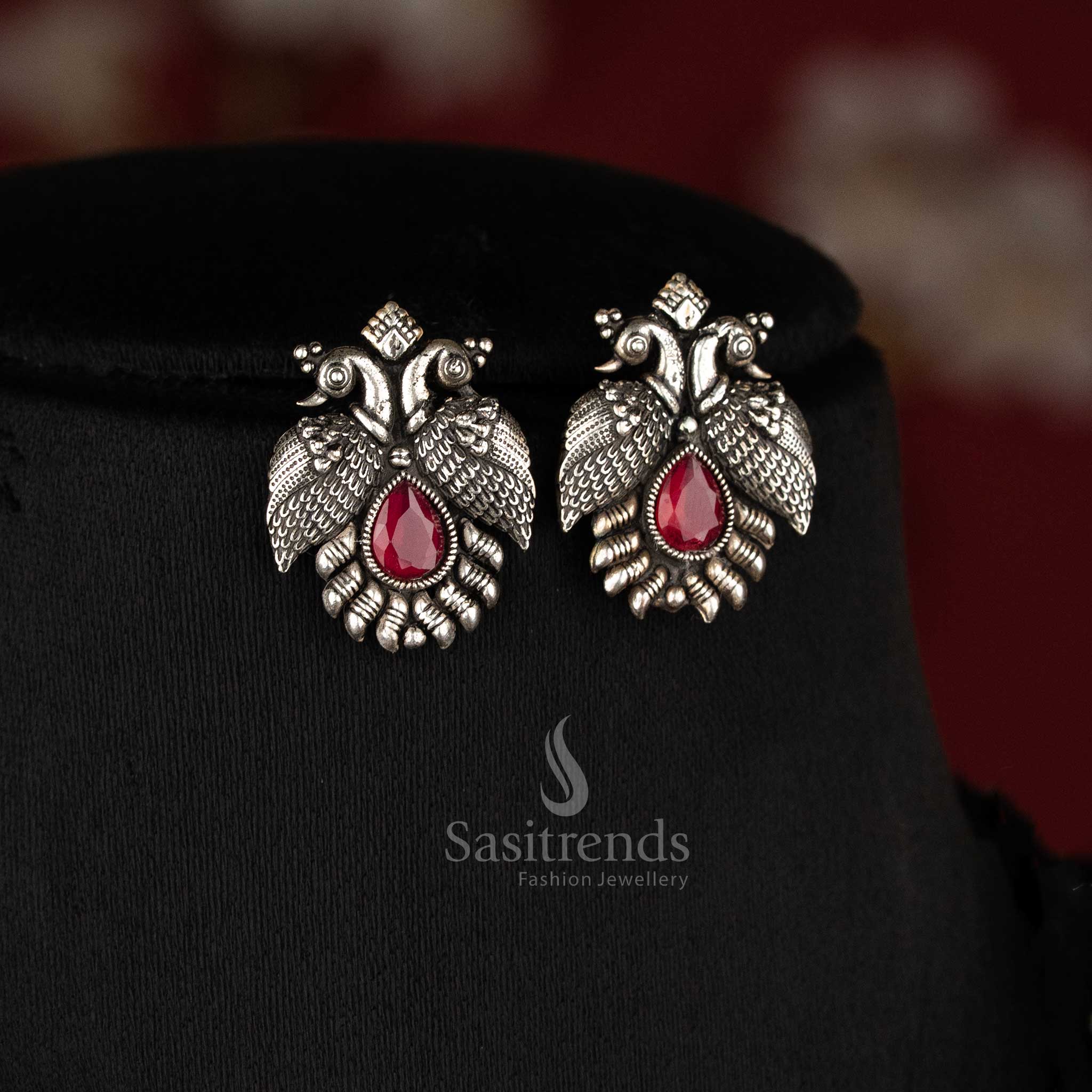 Royal handcrafted oxidised Kushi necklace set in silver, featuring contrasting Ruby -tear drop stones and peacock-shaped earrings - Sasitrends 