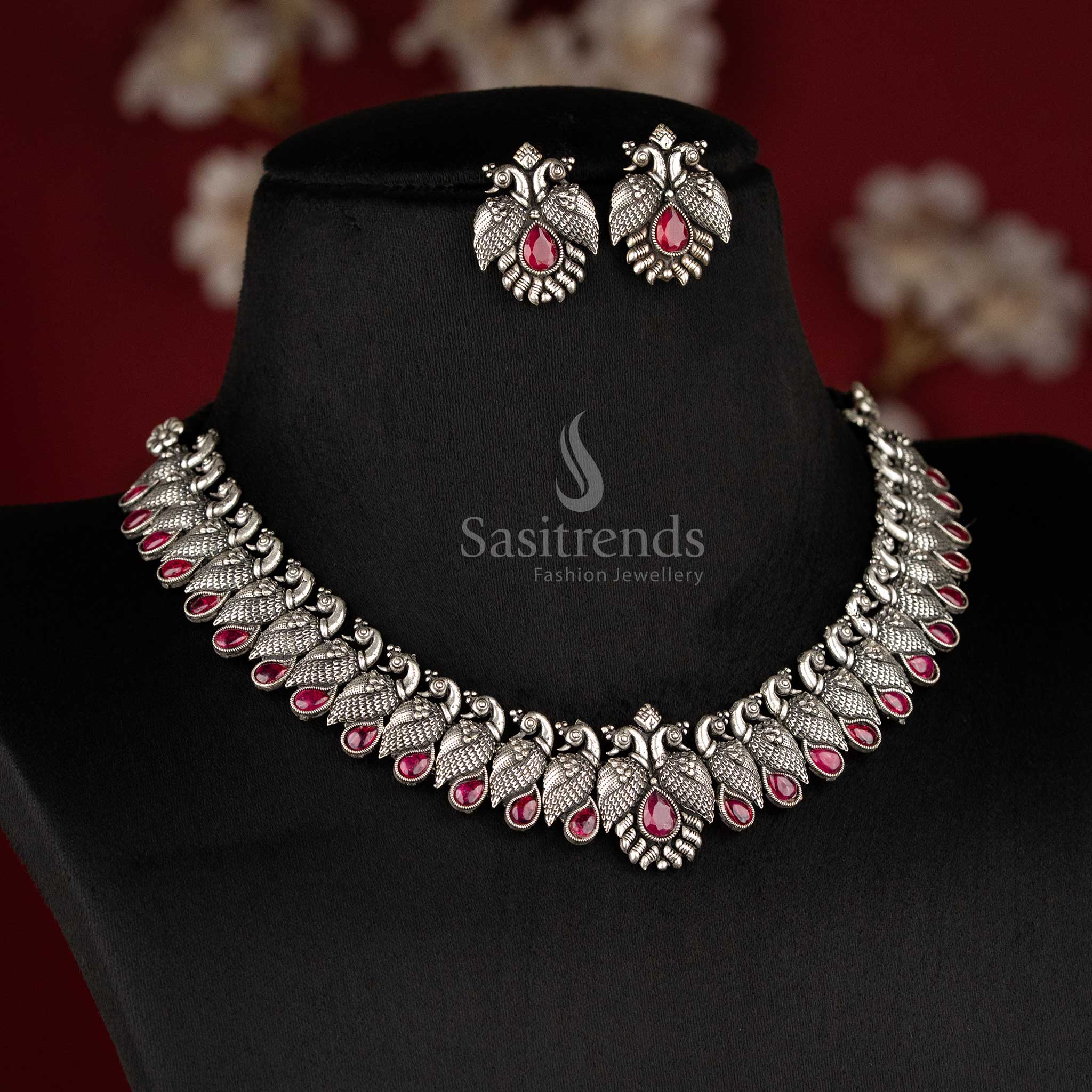 Royal handcrafted oxidised Kushi necklace set in silver, featuring contrasting Ruby -tear drop stones and peacock-shaped earrings - Sasitrends 