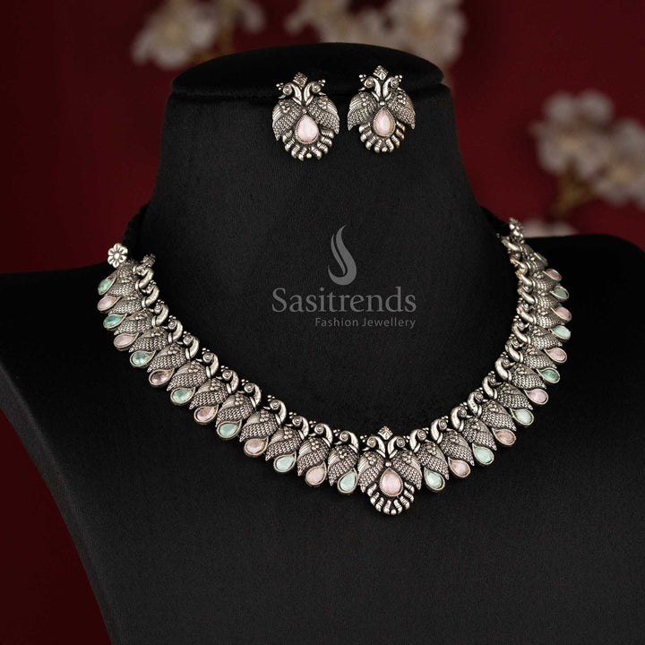 Royal handcrafted oxidised Kushi necklace set in silver, featuring contrasting pink mint -tear drop stones and peacock-shaped earrings - Sasitrends 