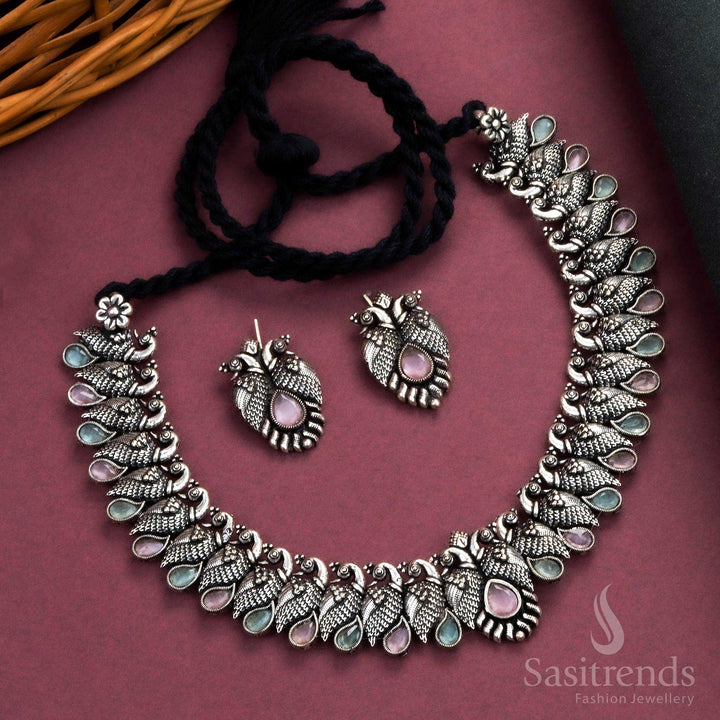 Royal handcrafted oxidised Kushi necklace set in silver, featuring contrasting pink-mint tear drop stones and peacock-shaped earrings - Sasitrends