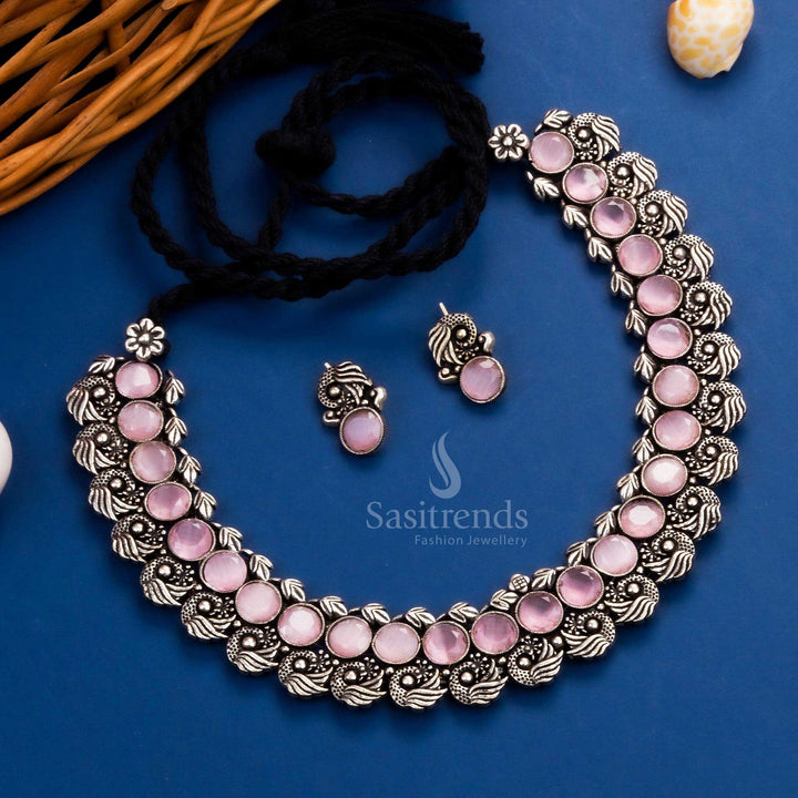 Luxurious antique peacock Kushi oxidised necklace set showcasing bold pink stones and intricate peacock earrings, a royal addition to festive jewellery - Sasitrends