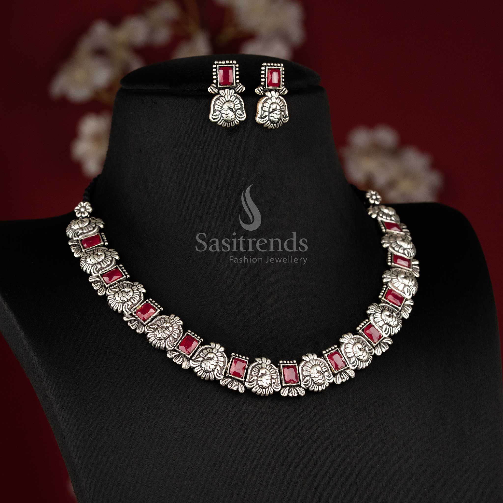 Timeless antique oxidised peacock Kushi necklace and earrings set featuring glowing ruby stones - Sasitrends