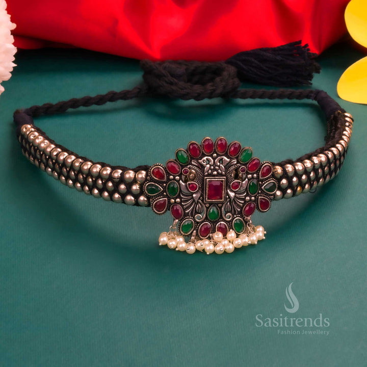 Grand bridal Kolhapuri oxidised choker featuring a ruby and green stone floral pendant with a pearl-beaded neckline - Sasitrends