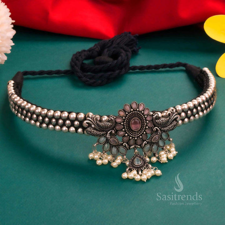 Classic Kolhapuri oxidised silver peacock pendant choker featuring mint-pink stones, beautifully designed with pearl beading, creating a regal ethnic jewellery piece - Sasitrends