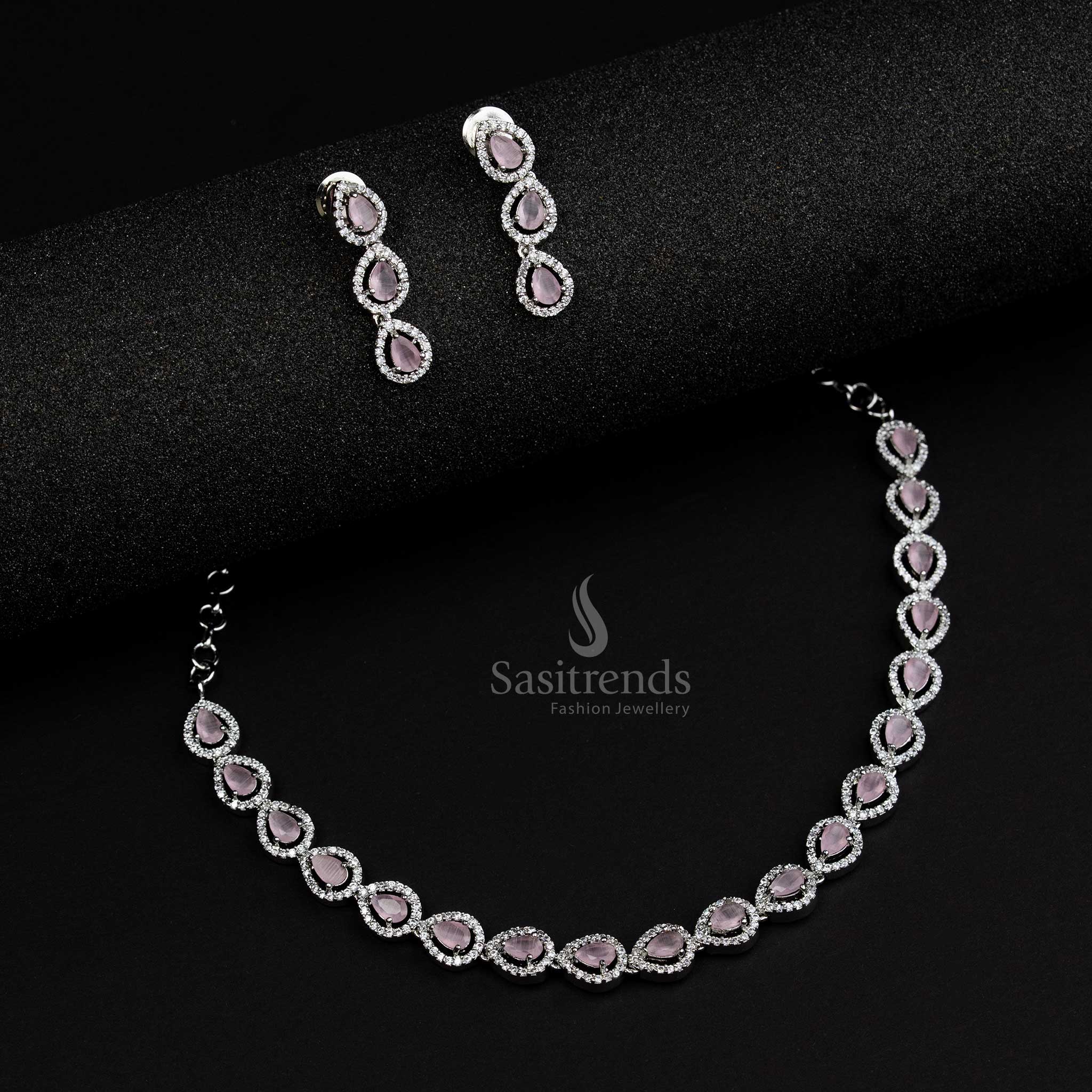 Chic rhodium silver plated jewellery set with pink stones in an artistic Thilak pattern, a feminine style statement for modern jewellery collections - Sasitrends

