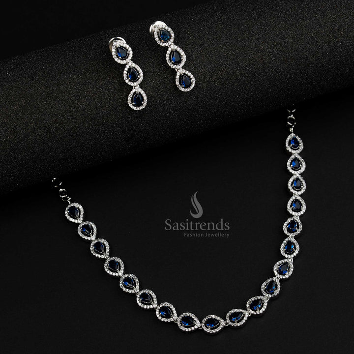Stylish rhodium silver plated jewellery set with striking blue American Diamond stones, crafted in a Thilak pattern, perfect for trendy party wear looks - Sasitrends